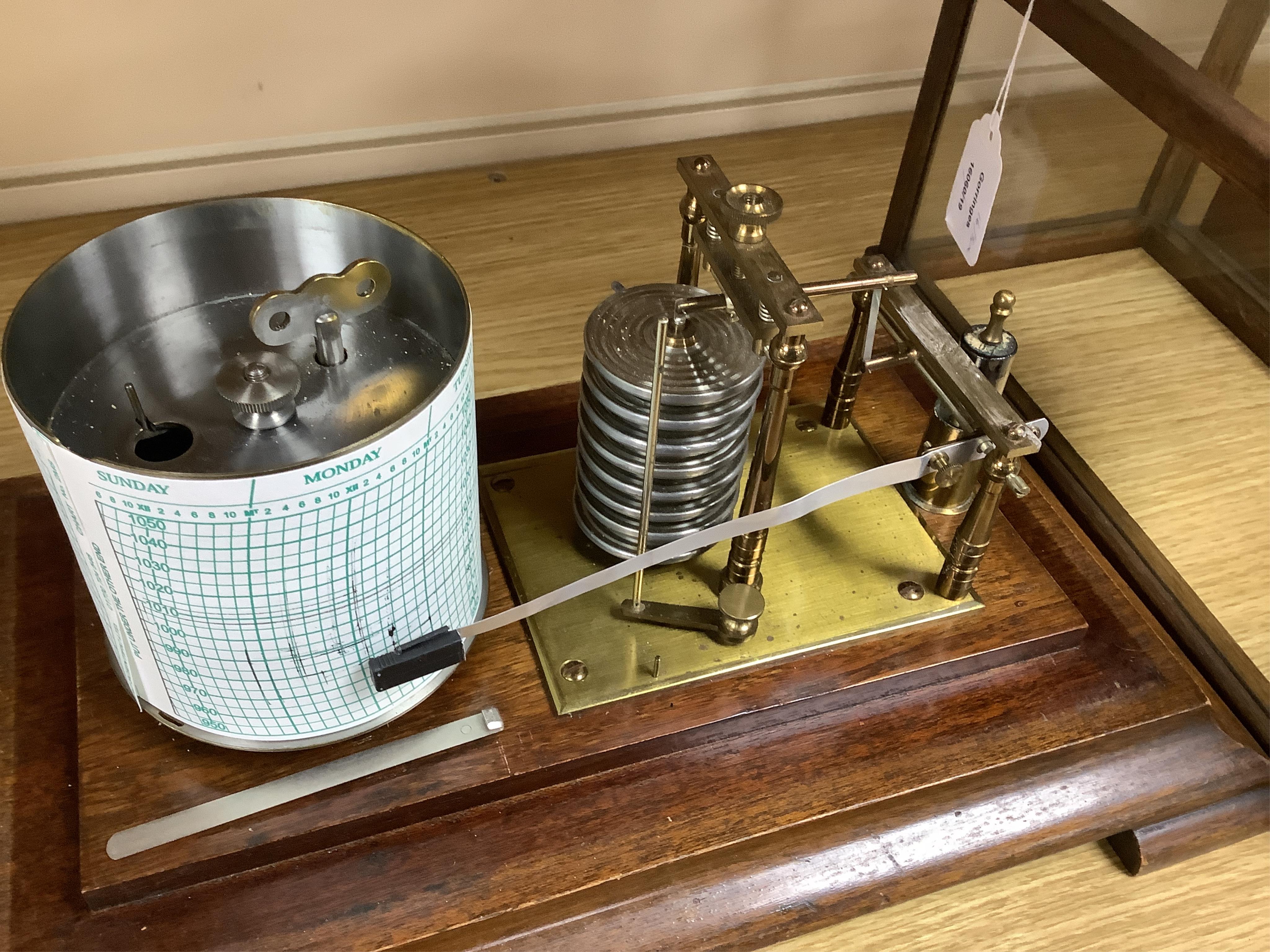 An early 20th century mahogany cased barograph by an unknown maker, with a quantity of unused papers.